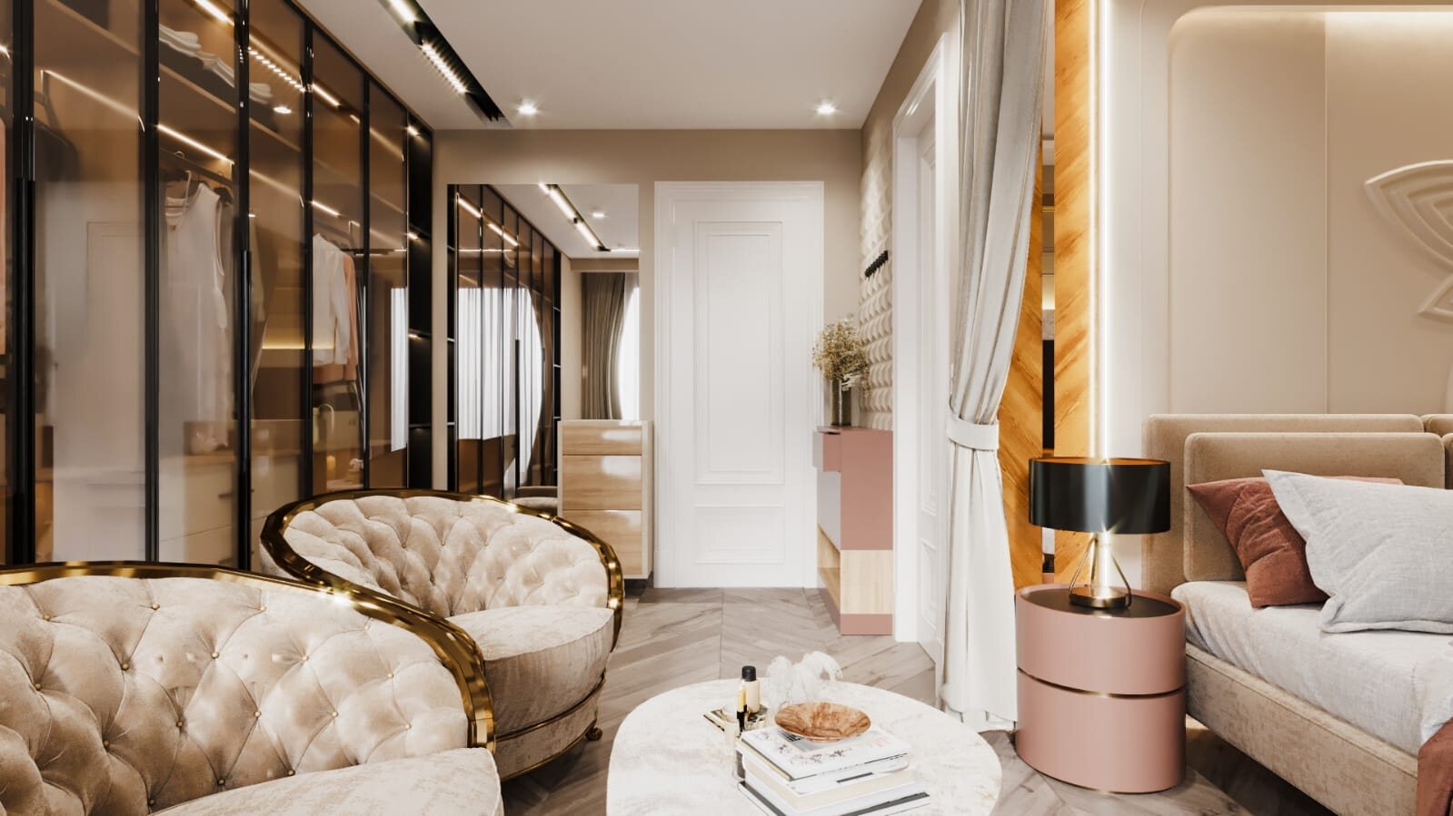 The dressing room looking through to the bed: a glazed and lit
                  wardrobe along one side, tufted chairs around a low marble table,
                  and a pink drum table under the lamp beyond.