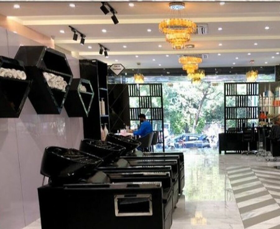 The wash bays as built, with rolled towels in the hexagonal niches and the street screened behind black grilles.