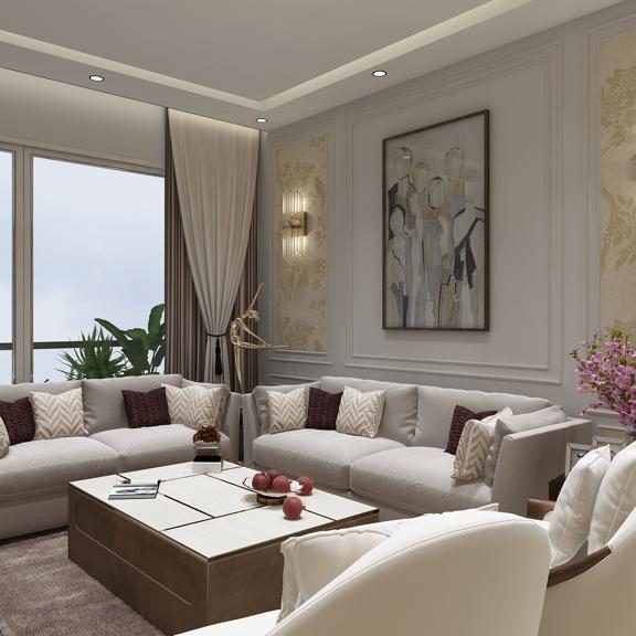The living room at the Gurugram residence: pale sofas and armchairs around a low marble table below panelled walls and a wall light.