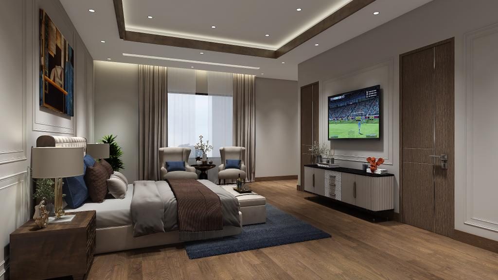 The master bedroom from the door: the television set into a timber
                  wall opposite the bed, with the armchairs and the window beyond.
