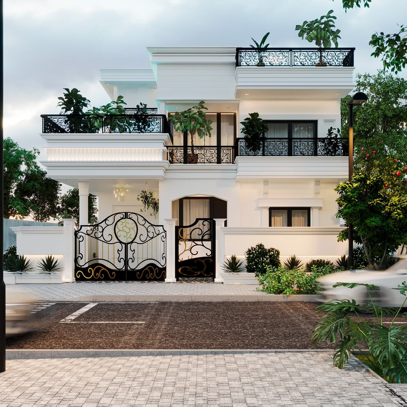 A white villa at dusk: wrought-iron gates to the drive, planted
                 balconies across both upper floors and a lit portico behind