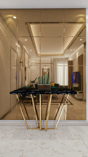 A dining nook lined in gold mirror, a black marble table on slender brass legs at its centre.