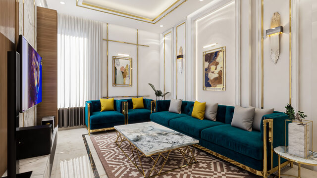 A long teal velvet sectional on a patterned rug, with gold accents and a pair of framed prints.