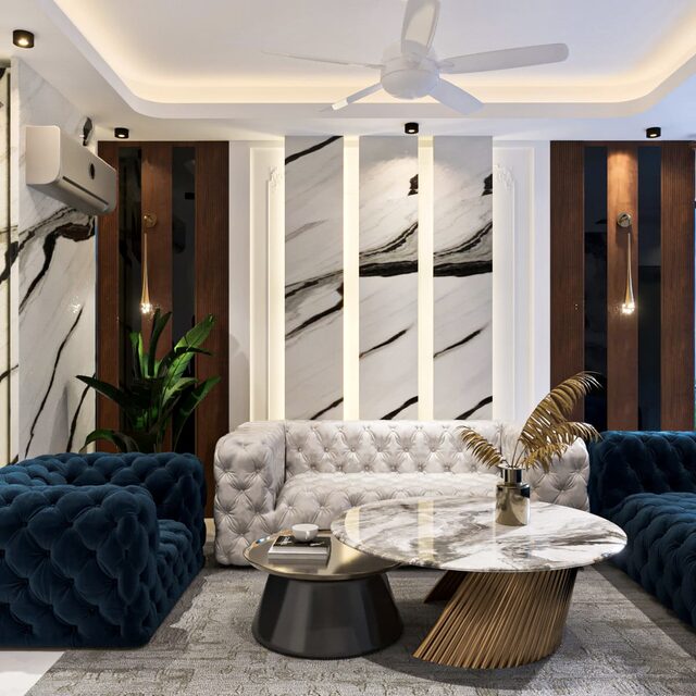 Fluted marble columns behind a tufted cream sofa, with navy velvet seating opposite.