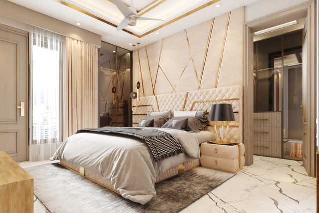 A cream bedroom with a gold-inlaid headboard wall over a marble floor.