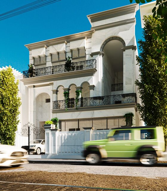 A white elevation of stacked arched balconies with iron railings.