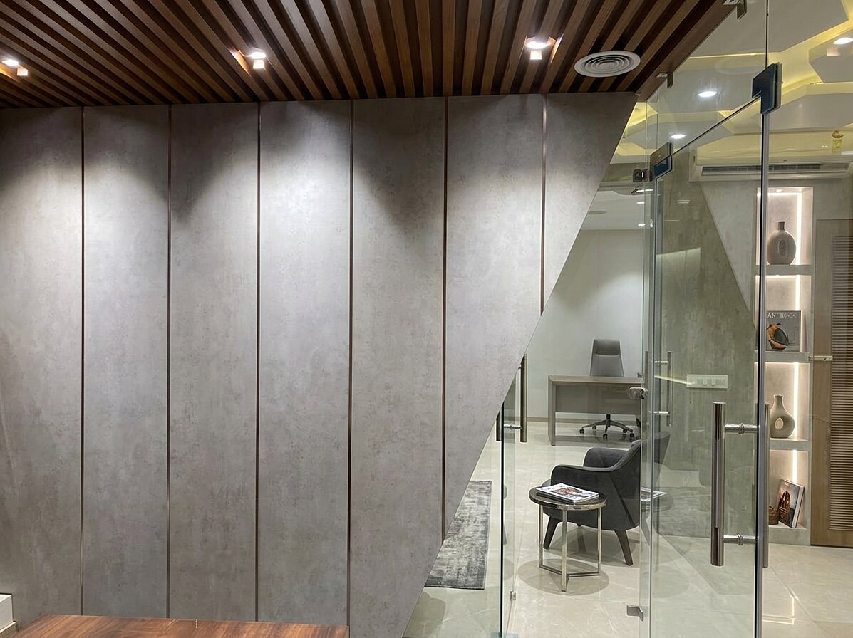The corridor between cabins, with slatted timber overhead and grey stone panelling to the walls.