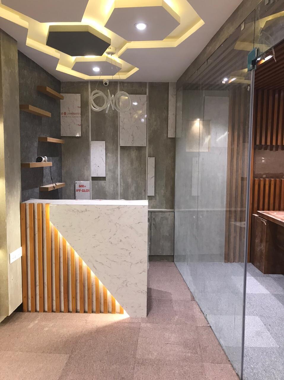Reception from the corridor side, showing the lit counter and the shelving beyond it.