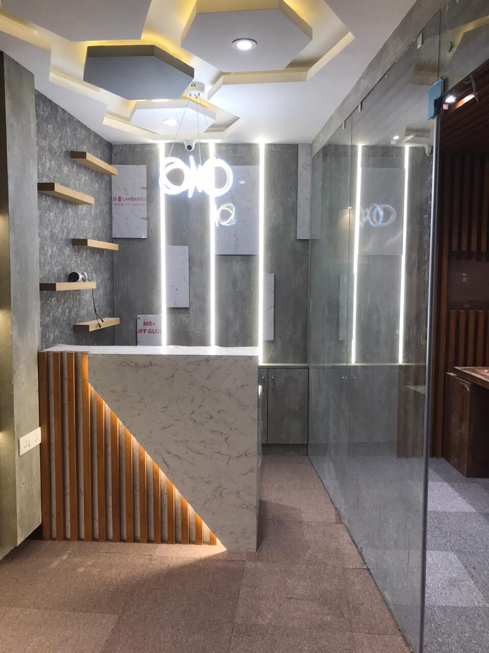 Reception seen from the entrance, with shelf niches to one side and the hexagonal ceiling above.