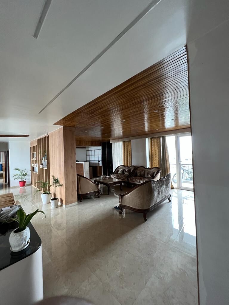 The long view through the apartment stood upright, the slat ceiling
                  curving away over the marble floor.