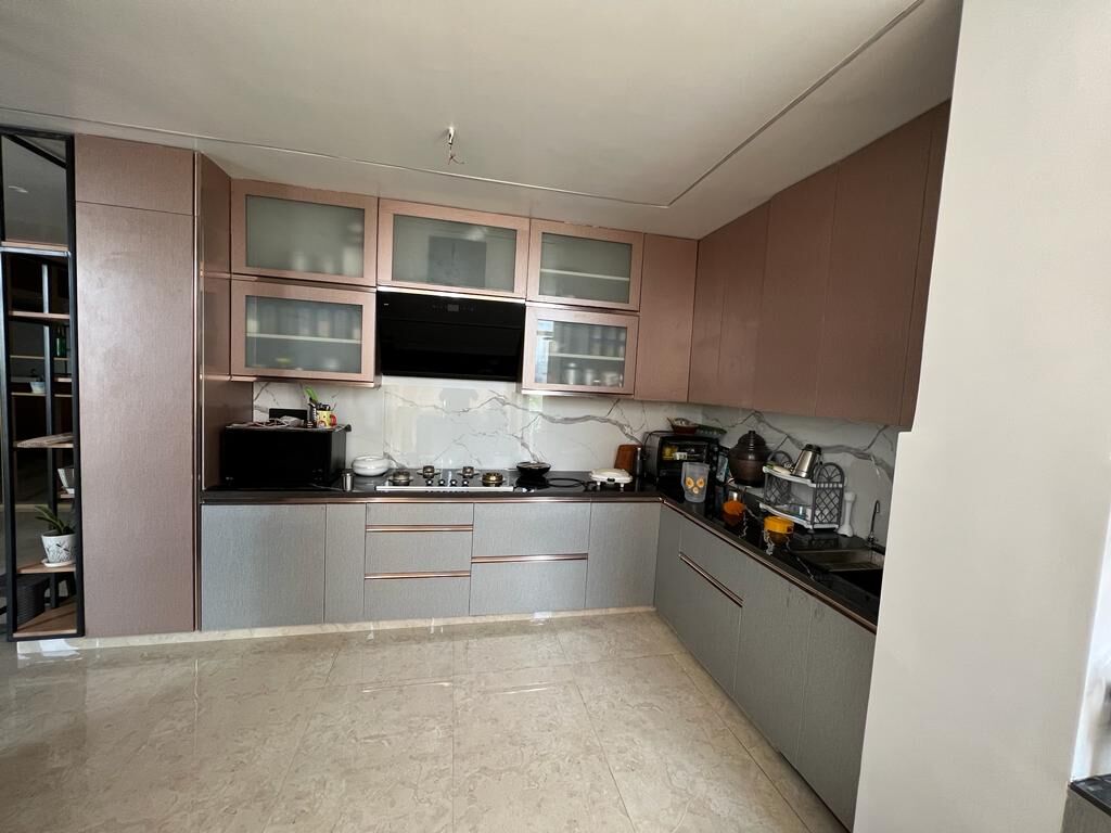 The kitchen wider: the L of the run with the television set into the
                  uppers and the appliances along the counter.